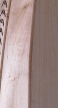 Photograph of a section of a harp made out of of Soft Maple